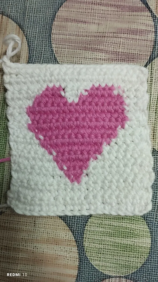 Handmade crochet heart coaster in pink & cream