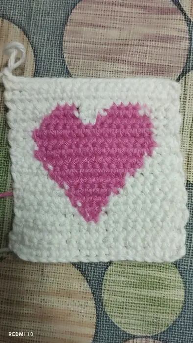 Handmade crochet heart coaster in pink & cream