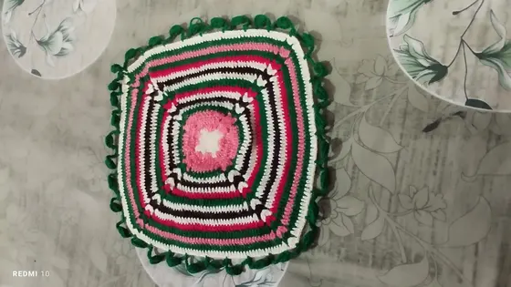 Handmade crochet square mat in pink, green & white