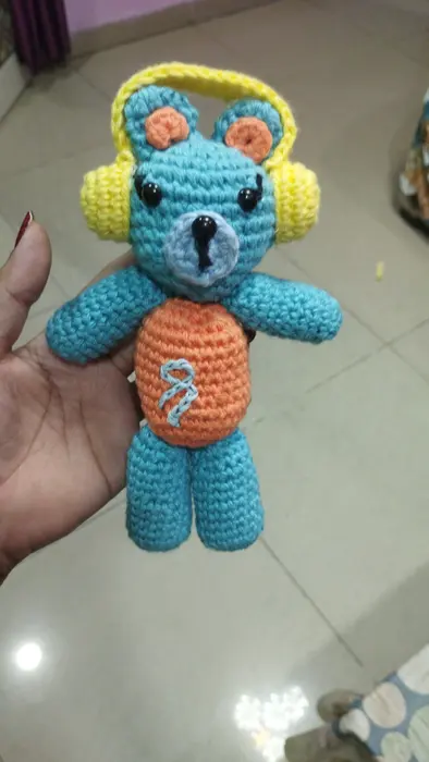 Handmade crochet teddy with headphones in blue & orange