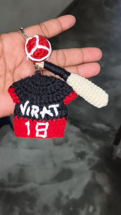 Handmade crochet cricket jersey keychain in black, red & white