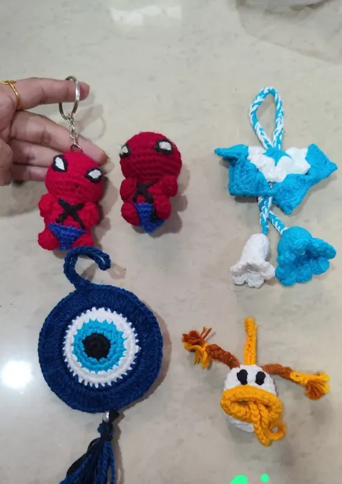 Handmade crochet evil eye, duck & bell charms in multicolour