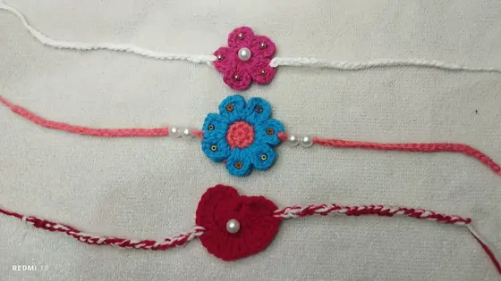 Handmade crochet rakhi in pink, blue & red